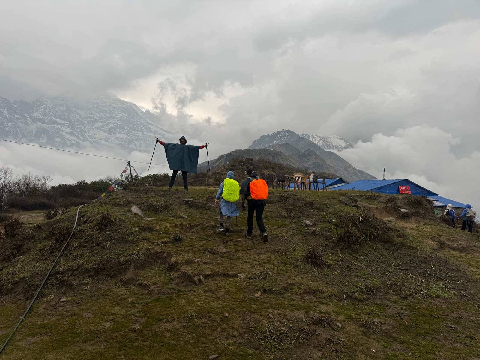 Trekkers on the open ridge near High Camp as cloud sweeps across the snow peaks